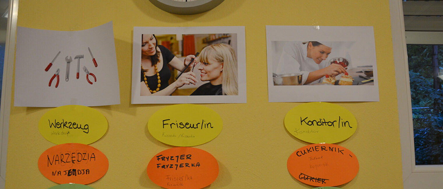 Tafel aus dem Junghandwerkeraustausch mit Namen von Berufen in den Sprachen polnisch, französisch und deutsch